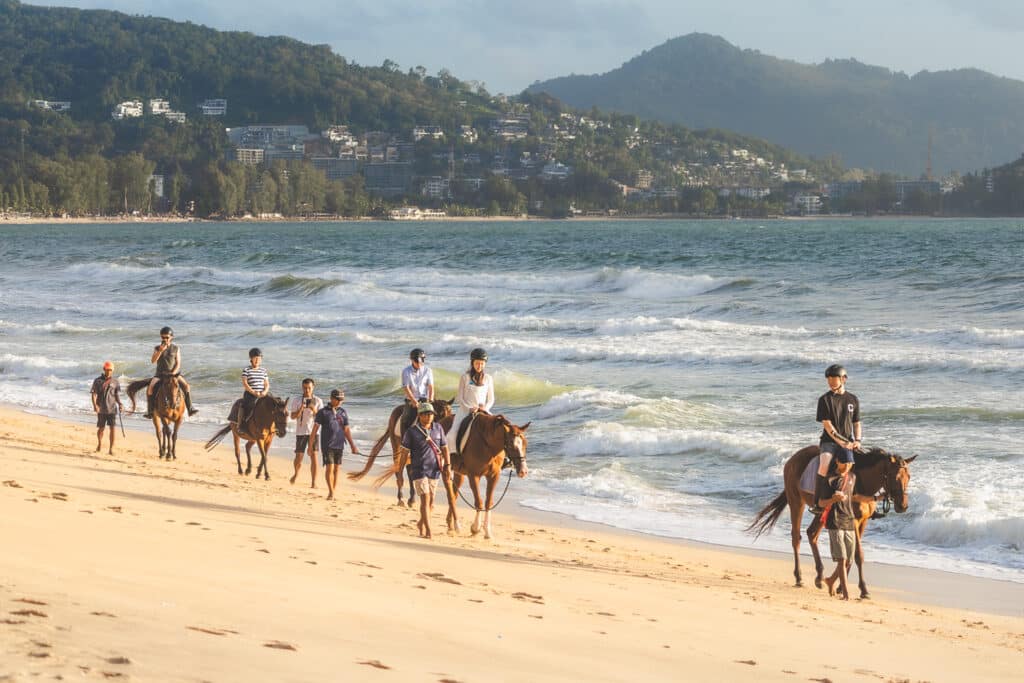 Horseback riding along the beach at sunset in Phuket, perfect for couples and travelers.